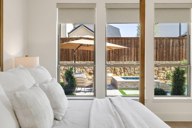 bedroom with wood finished floors and baseboards