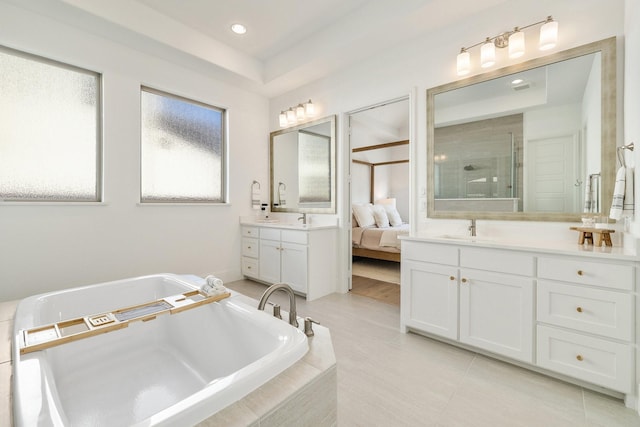 full bath with a sink, a shower stall, connected bathroom, a washtub, and two vanities
