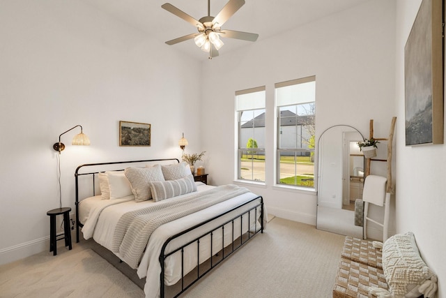 carpeted bedroom featuring a ceiling fan and baseboards