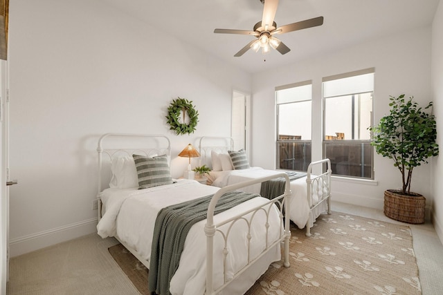 bedroom with baseboards, ceiling fan, and light colored carpet
