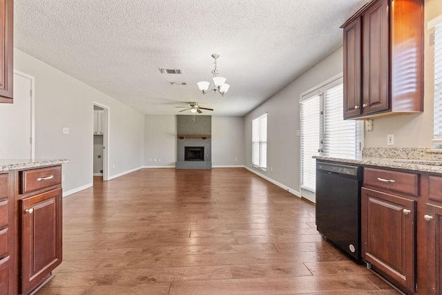 4109 Orchard Hill Dr, Arlington, TX 76016 - kitchen with a textured ceiling, visible vents, dishwasher, a brick fireplace, and ceiling fan with notable chandelier
