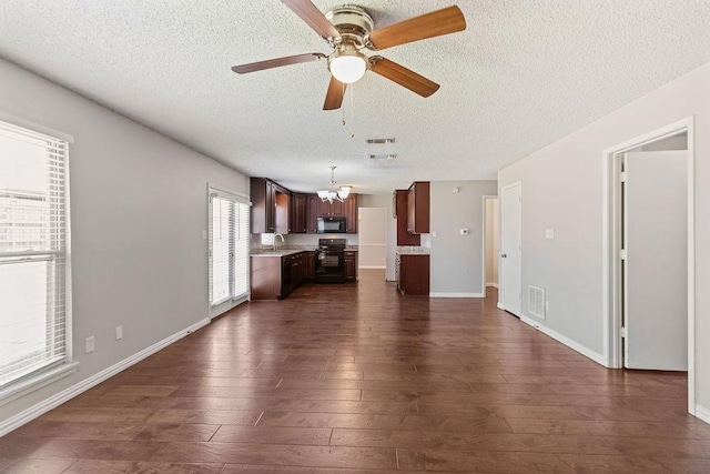 4109 Orchard Hill Dr, Arlington, TX 76016 - unfurnished living room featuring a textured ceiling, visible vents, dark wood-style floors, and ceiling fan with notable chandelier