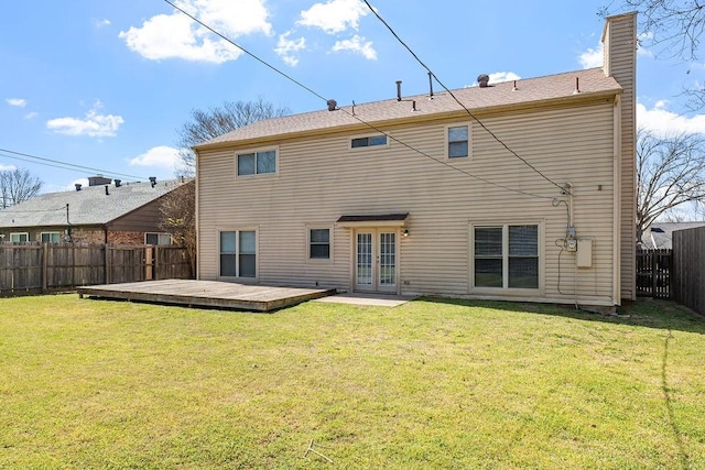 4109 Orchard Hill Dr, Arlington, TX 76016 - rear view of property featuring a fenced backyard, a lawn, a chimney, a deck, and french doors