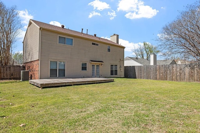 4109 Orchard Hill Dr, Arlington, TX 76016 - rear view of property with a wooden deck, central air condition unit, a fenced backyard, a lawn, and french doors