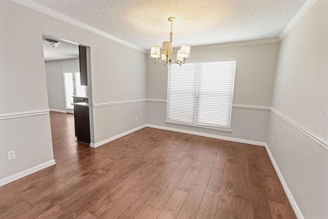 4109 Orchard Hill Dr, Arlington, TX 76016 - unfurnished dining area featuring hardwood / wood-style floors, baseboards, a notable chandelier, and a textured ceiling