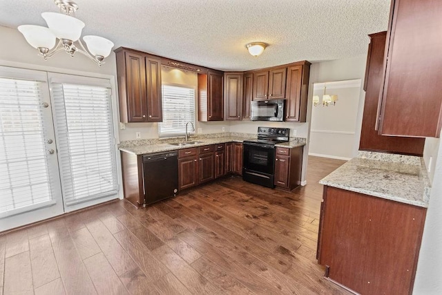4109 Orchard Hill Dr, Arlington, TX 76016 - kitchen featuring light stone countertops, a sink, dark wood-style flooring, a notable chandelier, and black appliances