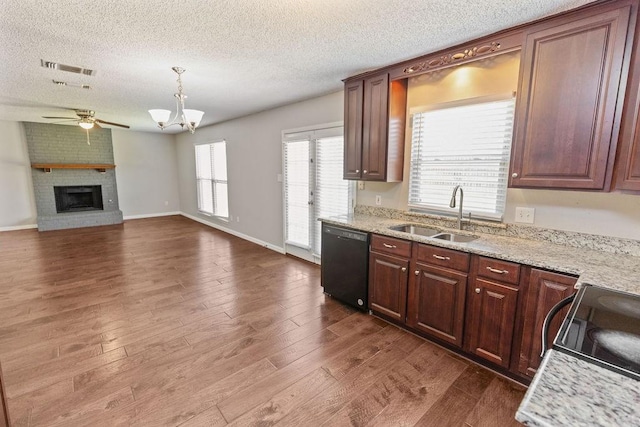4109 Orchard Hill Dr, Arlington, TX 76016 - kitchen featuring a sink, dishwasher, a brick fireplace, dark wood-type flooring, and ceiling fan with notable chandelier