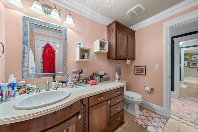 bathroom with vanity, crown molding, toilet, visible vents, and baseboards