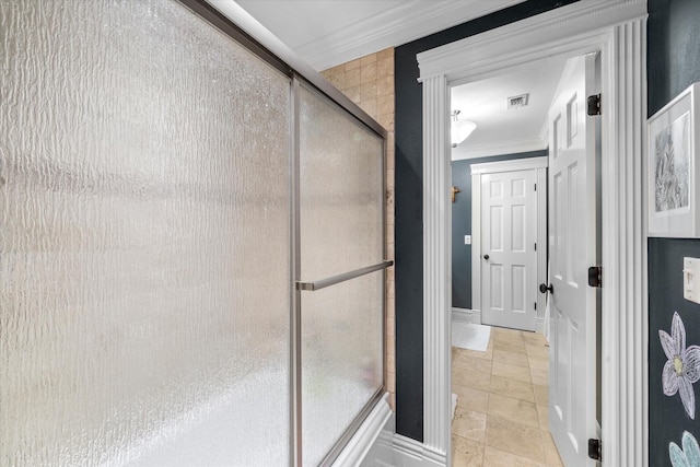 bathroom featuring crown molding, a stall shower, tile patterned flooring, and visible vents
