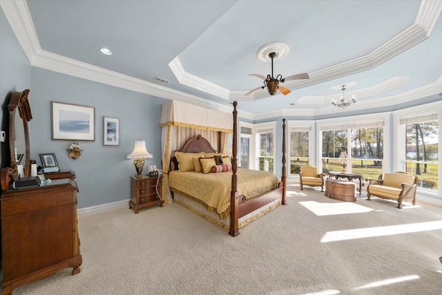 bedroom with visible vents, ornamental molding, carpet, and a tray ceiling