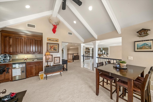 interior space featuring beamed ceiling, visible vents, light carpet, and ornate columns