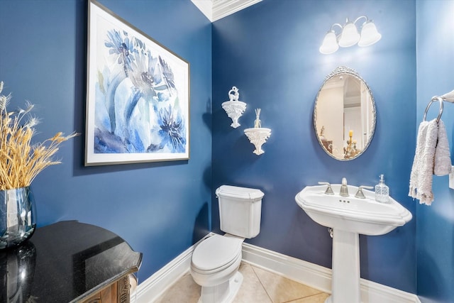 bathroom with toilet, tile patterned flooring, and baseboards