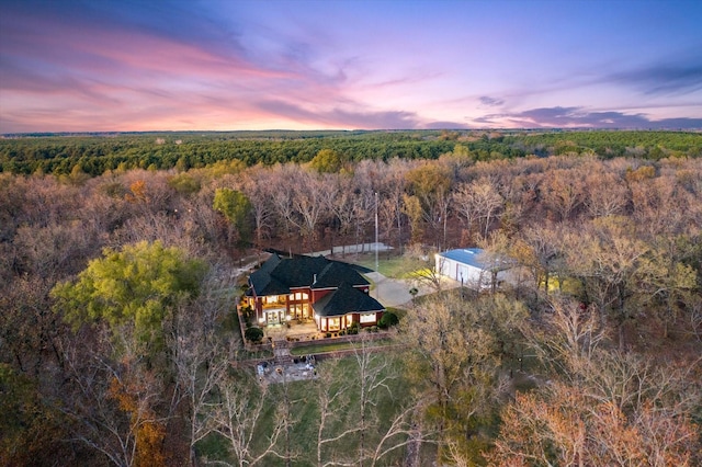 birds eye view of property with a wooded view