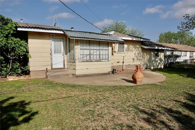 back of property with a patio area, metal roof, a lawn, entry steps, and fence