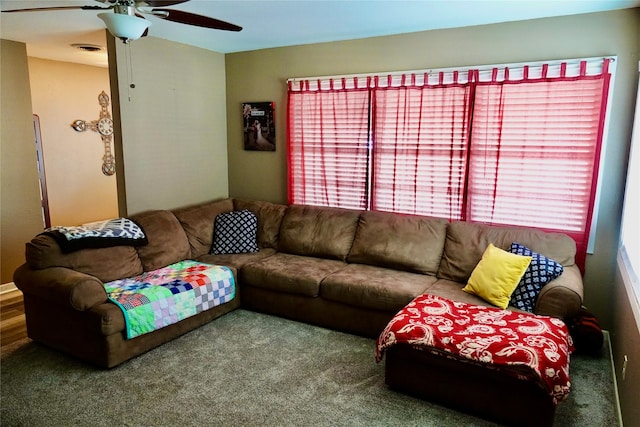 living room featuring visible vents, a ceiling fan, and carpet flooring
