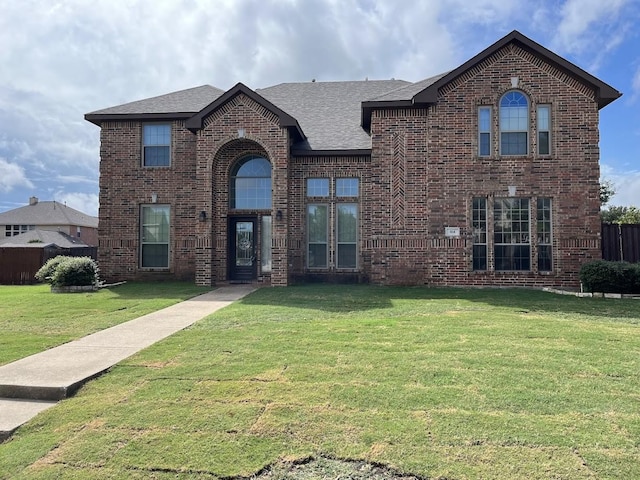 104 Misty Glen Ln, Murphy, TX 75094 - traditional home featuring brick siding, fence, a shingled roof, and a front yard