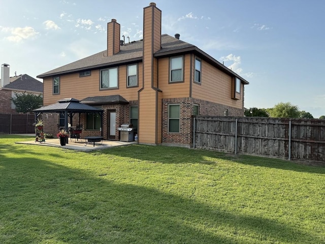 104 Misty Glen Ln, Murphy, TX 75094 - back of house featuring fence, a gazebo, a patio, and brick siding