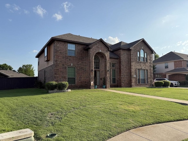 104 Misty Glen Ln, Murphy, TX 75094 - traditional-style house featuring brick siding, fence, and a front yard