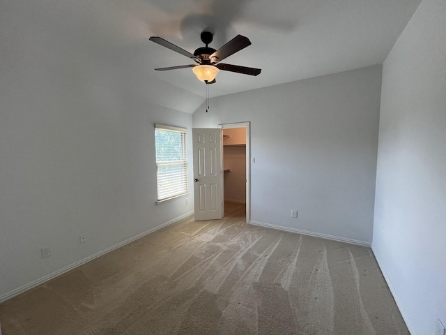104 Misty Glen Ln, Murphy, TX 75094 - unfurnished bedroom with lofted ceiling, ceiling fan, baseboards, light carpet, and a walk in closet