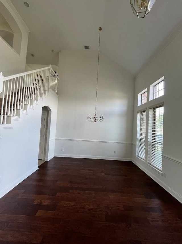 104 Misty Glen Ln, Murphy, TX 75094 - unfurnished dining area featuring wood finished floors, high vaulted ceiling, and arched walkways