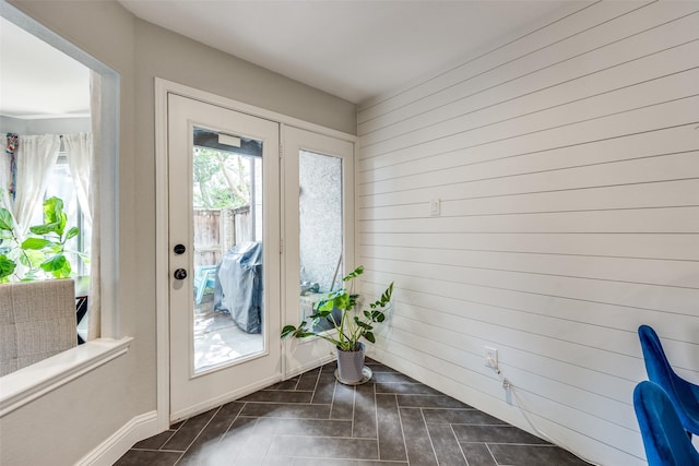 doorway to outside featuring baseboards