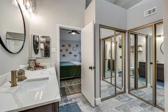 full bath featuring visible vents, ensuite bathroom, toilet, vanity, and a ceiling fan