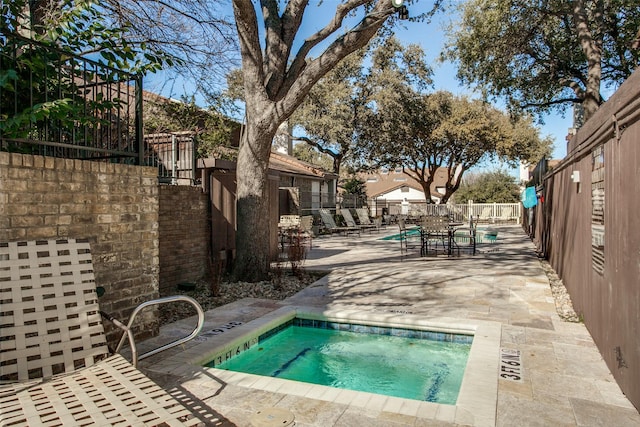 pool featuring fence and a patio area