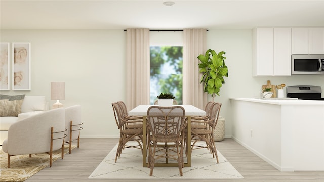 dining room featuring light wood-type flooring and baseboards