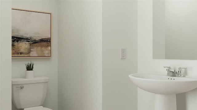 half bath with toilet and a sink