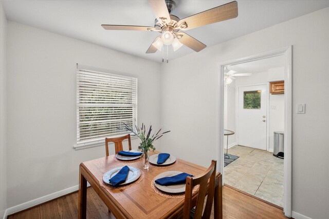 1207 W Tucker Blvd, Arlington, TX 76013 - dining room featuring light wood-style floors, baseboards, and a ceiling fan