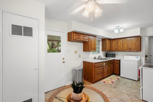 1207 W Tucker Blvd, Arlington, TX 76013 - kitchen with washer / dryer, stainless steel microwave, brown cabinets, and a sink