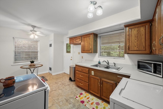 1207 W Tucker Blvd, Arlington, TX 76013 - kitchen featuring a sink, light countertops, stove, stainless steel microwave, and white electric stove
