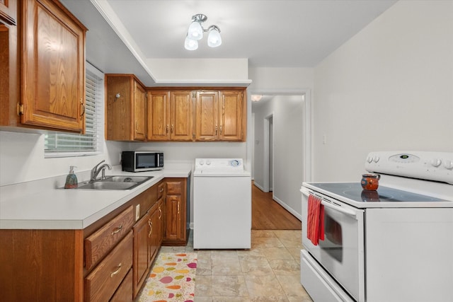 1207 W Tucker Blvd, Arlington, TX 76013 - kitchen featuring brown cabinets, electric range, a sink, washer / clothes dryer, and stainless steel microwave