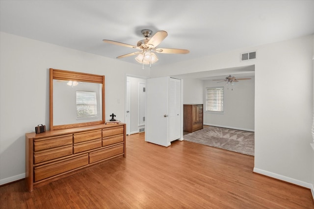 1207 W Tucker Blvd, Arlington, TX 76013 - bedroom featuring baseboards, light wood finished floors, ceiling fan, and visible vents