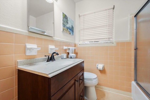 1207 W Tucker Blvd, Arlington, TX 76013 - full bath featuring vanity, tile patterned flooring, wainscoting, toilet, and tile walls