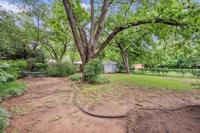 1207 W Tucker Blvd, Arlington, TX 76013 - view of yard with an outbuilding, a shed, and a fenced backyard