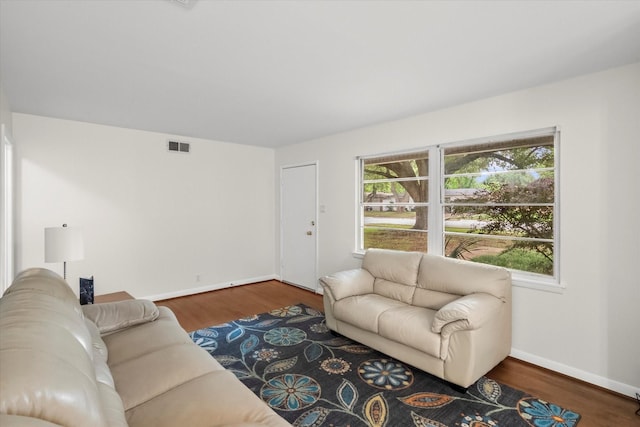 1207 W Tucker Blvd, Arlington, TX 76013 - living room featuring baseboards, visible vents, and wood finished floors