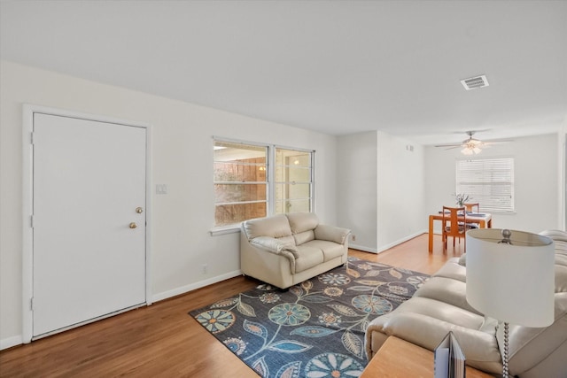 1207 W Tucker Blvd, Arlington, TX 76013 - living room with visible vents, a ceiling fan, baseboards, and wood finished floors