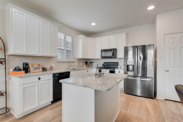 1015 Norias Dr, Forney, TX 75126 - kitchen with black appliances, a sink, white cabinetry, light wood-style floors, and decorative backsplash