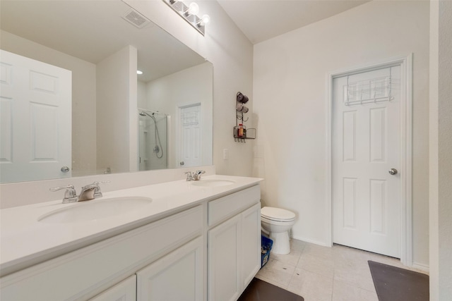 1015 Norias Dr, Forney, TX 75126 - full bath featuring tile patterned flooring, a stall shower, toilet, and double vanity