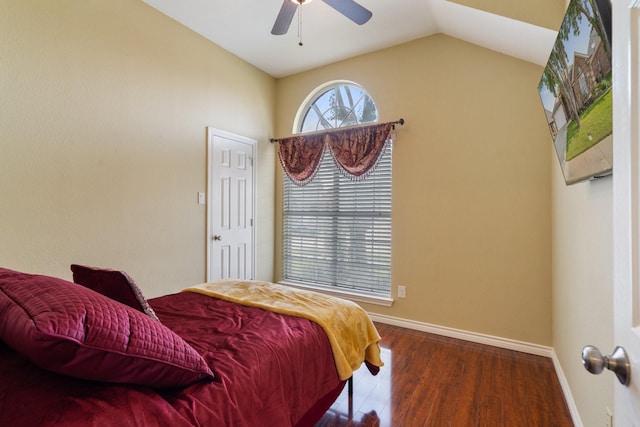 bedroom featuring lofted ceiling, a ceiling fan, wood finished floors, and baseboards