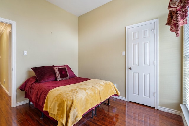 bedroom with wood finished floors and baseboards