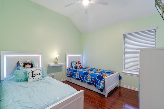 bedroom featuring wood finished floors, ceiling fan, vaulted ceiling, and baseboards