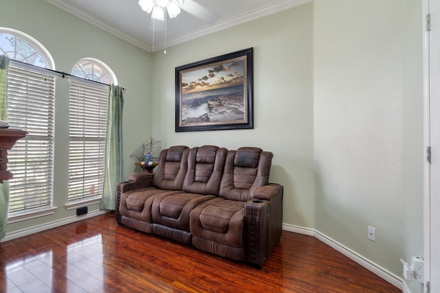 living room with baseboards, wood finished floors, a ceiling fan, and crown molding