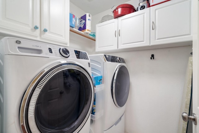 washroom featuring cabinet space and independent washer and dryer