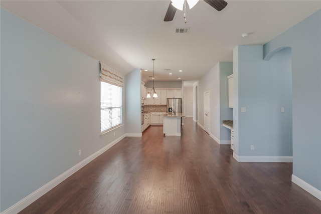 3017 Bella Lago Dr, Denton, TX 76210 - unfurnished living room with visible vents, baseboards, recessed lighting, dark wood-type flooring, and ceiling fan with notable chandelier