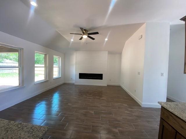 1716 Oldham Ln, Abilene, TX 79602 - unfurnished living room featuring a ceiling fan, baseboards, and a healthy amount of sunlight