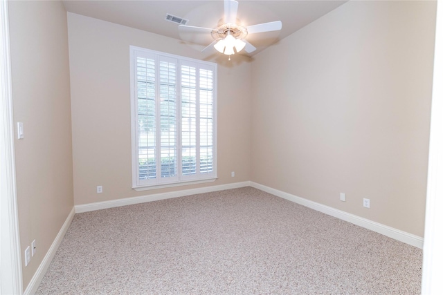 carpeted empty room featuring baseboards, a ceiling fan, and visible vents
