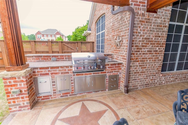 view of patio / terrace with fence, grilling area, and area for grilling
