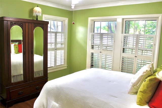 423 S O Connor Rd, Irving, TX 75060 - bedroom with crown molding, wood finished floors, and access to exterior